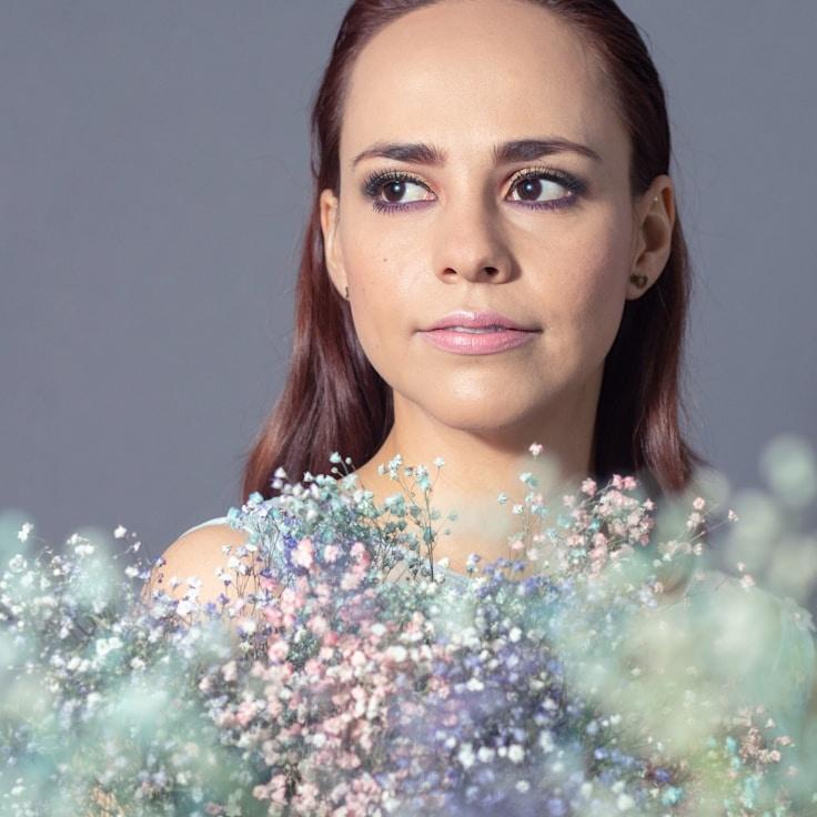 Kaveri Mehta, Lead Design Curator at Cedar Panel Market, reviewing corporate floral arrangements